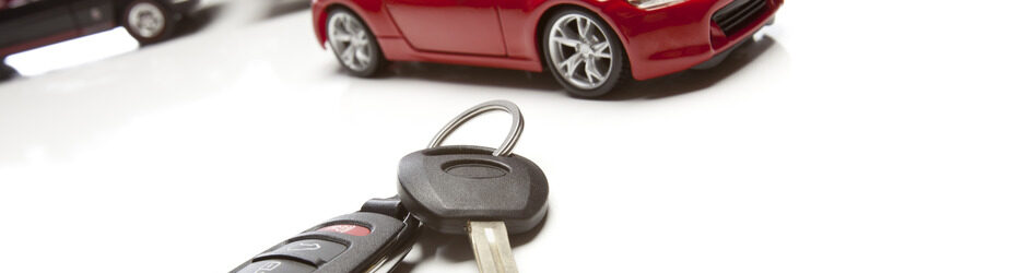 Car Keys and Several Sports Cars on White Background.